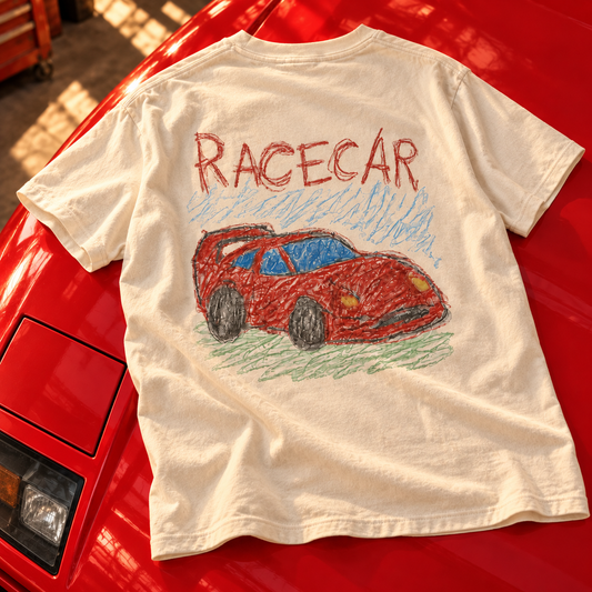 Styled mockup of the Ivory RACECAR tee draped over a red Ferrari F40, showing the red car artwork on the back