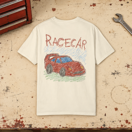 Styled mockup of the Ivory RACECAR tee, back view with red car artwork, on a garage workbench
