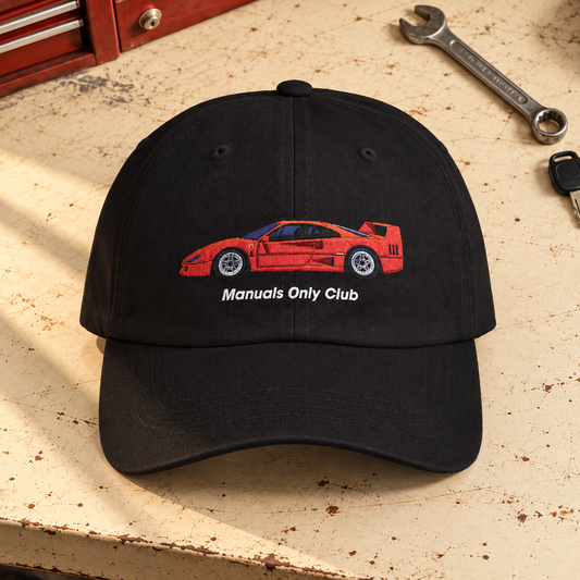 Styled mockup of the Black Retro Hat with red car embroidery on a garage workbench