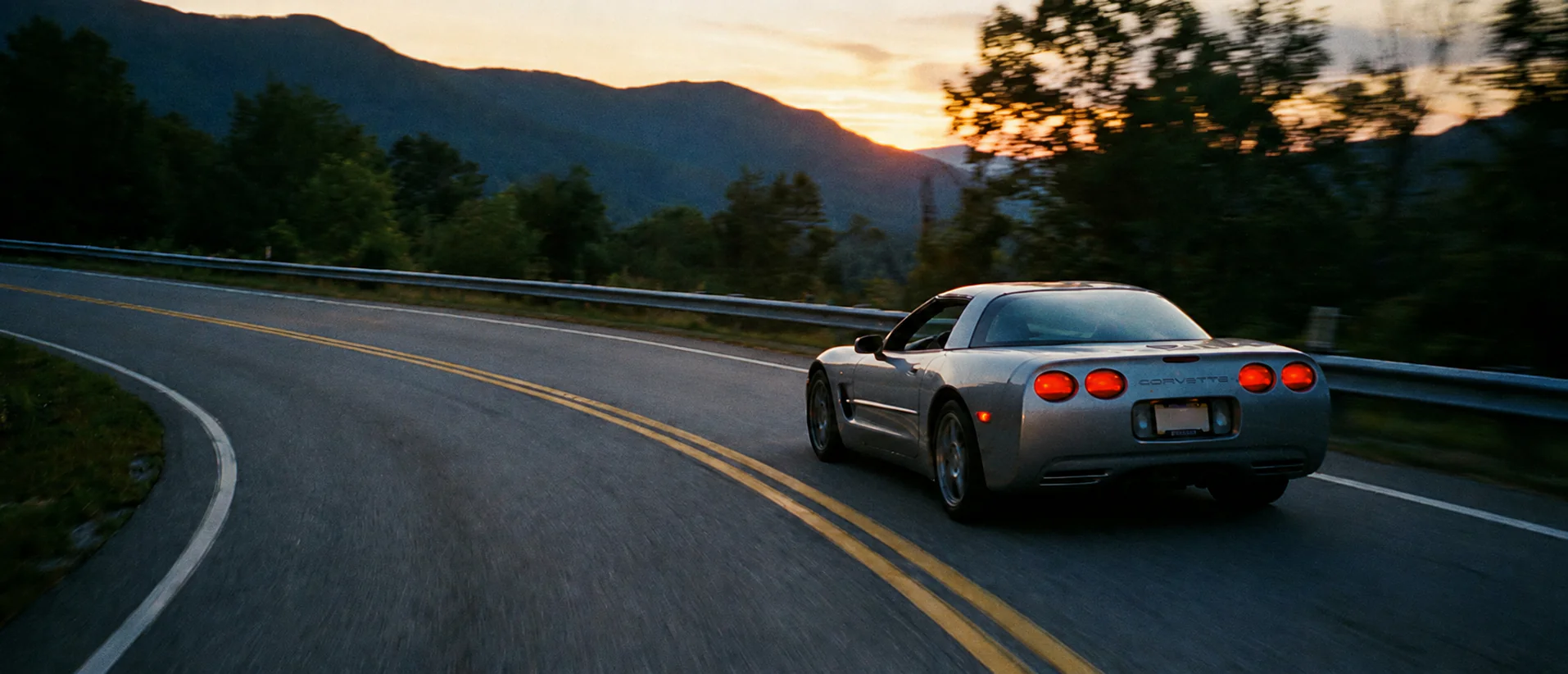 Sports car on a mountain road at dusk, shot on film